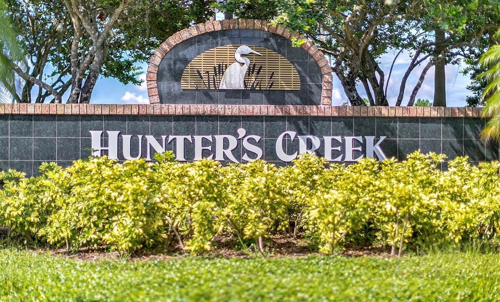 hunter creek sign with bushes